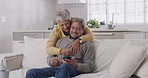 Happy, loving and relaxing couple checking phone for messages or browsing the internet while doing online shopping at home. Mature husband and wife using banking app to check retirement savings