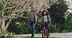 First ride, bike and happy child outdoors learning to cycle alone on a bicycle in a street. Smiling, clapping and supporting or proud grandpa having a fun bonding moment with his granddaughter.