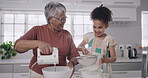 Baking, teaching and learning grandmother and little girl having fun cooking in a family kitchen. Smiling, happy and laughing senior female and cute child bonding and enjoying the day together inside