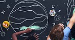 Multi ethnic children drawing and coloring pictures together with chalk on blackboard, close up time lapse. Happy kids enjoying fun and showing creativity in pre school. Learning through enjoyment