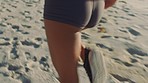 Active, fit and sporty woman running, sprinting or jogging on the seashore at the beach. One focused, serious and determined female training, doing cardio and exercising in nature during summer