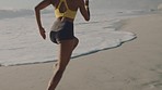 Active, fit and sporty woman running, sprinting or jogging on the seashore at the beach. One focused, serious and determined black female training, doing cardio and exercising in nature during summer