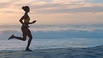 Active, fit and athletic woman running on the beach with copy space for her morning exercise routine. Female runner sprinting on the sea or ocean shore for her outdoor fitness or cardio workout