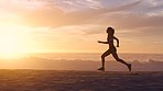 Fit, active and sporty female running, jogging and exercising on the beach during sunset in summer. One energetic, determined and athletic woman training, doing cardio and sprinting on the seashore