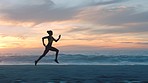 Silhouette of active, healthy and fit woman running on beach at sunset with copy space outside. Beautiful, calm and quiet nature scene at dawn or dusk of female exercising and training near the sea