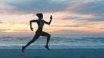 Silhouette of an active, healthy and fit woman running on a beach against a sunset sky with copy space. Young female looking focused, serious and determined, exercising and training near the ocean