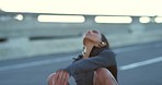 Running, sports and exercise with a tired woman athlete taking a break from her workout on a bridge in the city. Fitness, training and sweat with a young female exercising for health and cardio