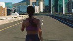 Fitness, woman and running in the city for health exercise and workout on a warm summer day. Fit, athletic and active female runner in routine training for endurance, energy and life on urban bridge.