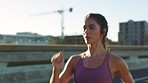 Health, fitness and energy with woman running, training and exercise on an urban highway. Serious female practice speed and performance with intense cardio workout in a city, speed and endurance goal