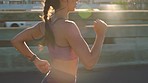 City running, motivation and sport woman in fitness training on a street. Wellness, health and professional athlete or runner doing speed workout exercise outdoor with endurance energy in urban town