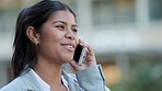 Closeup portrait of a happy woman talking on a phone call, outdoors in the city. Beautiful female smiling, speaking and receiving good news, walking outside a office, with copyspace background.