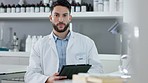 Portrait of a happy health care professional doing research on a tablet in a modern lab. Confident scientist feeling positive about a breakthrough or discovery, searching for a cure for diseases