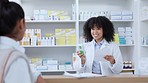 Pharmacist talking, helping and showing customer medicine in pharmacy and explaining prescription dosage. Medical healthcare professional with afro selling over the counter drugstore medication pills