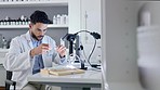 Scientist, doctor or clinical laboratory in a science lab busy conducting research and working on a dna test sample. Serious young male doctor doing a forensic experiment to develop a medical cure