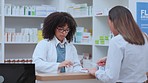 Pharmacist talking, helping and giving customer medicine in pharmacy after explaining prescription. Medical healthcare professional with afro selling drugstore medication pill after signing paperwork