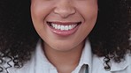 Face, mouth and eyes closeup of female with curly afro smiling, laughing and looking happy. Head portrait of beautiful, cute and young african girl with natural makeup showing cheerful expression 