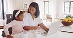 Daughter and working mother, single parent or small business entrepreneur typing on a laptop, pointing at the screen while doing remote work from home. Parent showing a child the business of her job