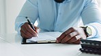 Writing, hands and paper work with a man applying for finance, a homeloan or mortgage bond at a desk in the office. Filling in a document for insurance, investment or to open a bank account closeup