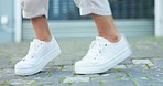 Feet, dance and woman shoes on the road moving and jumping to street music in the city. Closeup of a modern female dancer dancing in sneakers outdoor in nature. Lady in footwear doing a fun exercise.