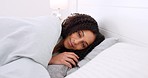 Sleep, bed and relax with a happy woman in the bedroom of her home, waking up and feeling fresh. Smile, rest and comfort with a young female lying under blankets and bedding in the morning in a house