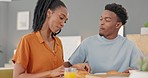 Happy, black couple and breakfast feeding at the dinner table for love, care and share in bonding relationship at home. African American man and woman smiling sharing morning meal together in romance