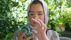 Muslim islamic woman with phone on social media app or 5g smartphone reading online communication internet news. Arab girl or young person in hijab with mobile technology cellphone typing message