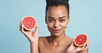 Vitamin c, grapefruit and skincare woman in studio with blue background mock up or copy space. Health, wellness and vegan lifestyle for skin care, beauty or detox African youth model face with mockup