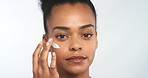 Skincare cream, face and black woman beauty cosmetic treatment for wellness and skin health. Portrait of a healthy female model putting on facial mask, moisturizer or sunscreen with white background