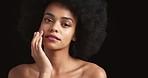 Black woman, afro and glowing skincare on studio background for wellness, health and face care. Portrait of young beauty model touching face with hands in self care with fashion hair and empowerment