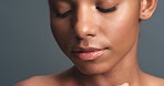 Beauty, skincare and art light on a woman touching and feeling her healthy, soft and smooth skin against studio background. Closeup of a natural and sensual model, wellness and dermatology routine