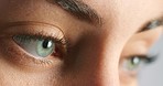 Eye, focus and vision of woman eyes extreme macro at optometrist to test her eyesight. Health, wellness and face of thinking female testing sight for optical prescription, contact lenses or eyewear.