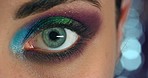 Beauty, eye, and woman with eyeshadow makeup and colorful eyelashes or mascara cosmetics portrait zoomed in. Products, glitters and young female model with dilated pupil and close up on night out
