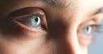 Zoom of Caucasian woman, blue eye blink in optical or vision wellness portrait. Macro view of young female face, with closeup on eyeball open and close to show healthy muscle movement.