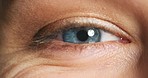 Closeup of a blue eye, eyesight and vision for optometry, eyecare and wellness of optical health. Macro zoom of a beautiful, natural and human iris or contact lens color of an awake woman.