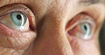 Vision, eyes and retirement with a senior woman at the optometrist for an eye test or exam for prescription eyewear or contact lenses. Closeup of an elderly female blinking, looking and seeing indoor