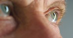 Eyes, vision and man watch or looking in optometry healthcare, wellness or eyesight exam closeup or zoom. Medical awareness, serious or natural human iris movement for anatomy with macro or closeup