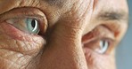 Eyes of elderly senior woman with poor mental health, blinking into light and forgetful or confused. A close up of tired wrinkles on skin around unhappy eye showing stress, fatigue and even dementia