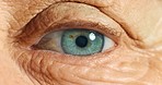 Eye vision and senior elderly man with eyesight problem, beginning symptoms of glaucoma. Wrinkles, green human eyes and closeup zoom of retirement person or pensioner alert at eye exam test