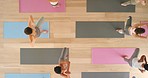 Meditation, exercise and yoga class overhead with women meditating at in a studio or fitness center. Relax, zen and workout by athletic female training and exercising, practice balance and position