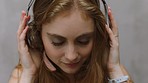 Music streaming, web radio and woman listening to audio on headphones to relax. Calm, freedom and peace mindset of a young person hearing a happy song moving her head to the track with happiness