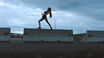 Woman, street and freestyle dancing in the city night light expressing body in hip hop choreography practice in urban background. Active female dancer in expressive dance energy and moves on a bridge