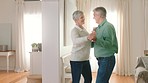 Retirement and senior couple dance to music to celebrate trust, romantic love and care in home living room together. Retired elderly dancer man and woman happy dancing with joy, smile and happiness