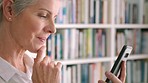 Mature woman, phone or thinking while reading internet news, funny blog or streaming comic movie in house library. Zoom on smile, happy or laughing senior with mobile research technology app in house