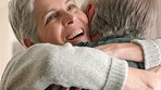 Love, couple and face with a senior woman hugging a man in their home and feeling excited together. Joy, retirement and romance with an elderly wife and husband embracing in their house with a smile