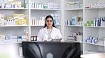 Checklist, computer and pharmacist working with medicine in a pharmacy store typing medical drugs on database. Young Indian healthcare worker in retail checking prescription medication at her job