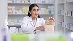 Pharmacist, healthcare shop and pharmacy woman worker packing a customer medicine order. Happy person from India working in a retail service, pills store and drugstore to help with medical stock