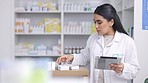 Pharmacist, healthcare and medicine with a woman nurse filling an online order with a tablet in the pharmacy. Medical, pills and insurance with a female health professional working in a drugstore