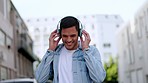 City man streaming music, with headphones and walking in the street with smile. Technology, freedom and internet, happy student listening to radio or podcast app online on his way to work or college.