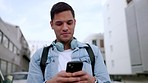 Man with phone smile while on social media, internet or online app reading a funny meme. Young male laugh while texting a contact on a mobile smartphone with communication on a 5g device on the web