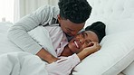 Relax, couple and love in bedroom kiss, rest and comfort in happy relationship together at home. Man and woman lying in bed relaxing, talk and smile in comfortable house and morning happiness